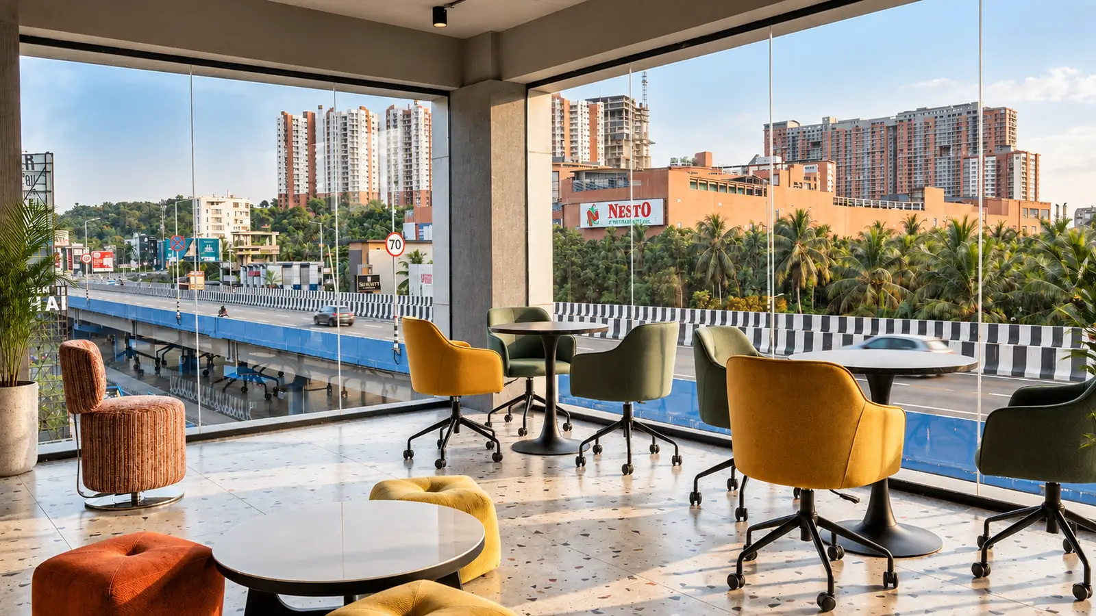 Community lounge overlooking the bypass at Spunic Calicut Bypass