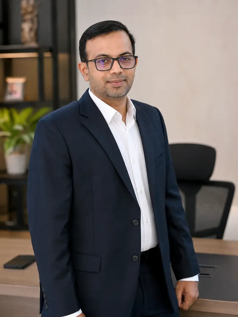 A professional in a navy blazer standing in an office