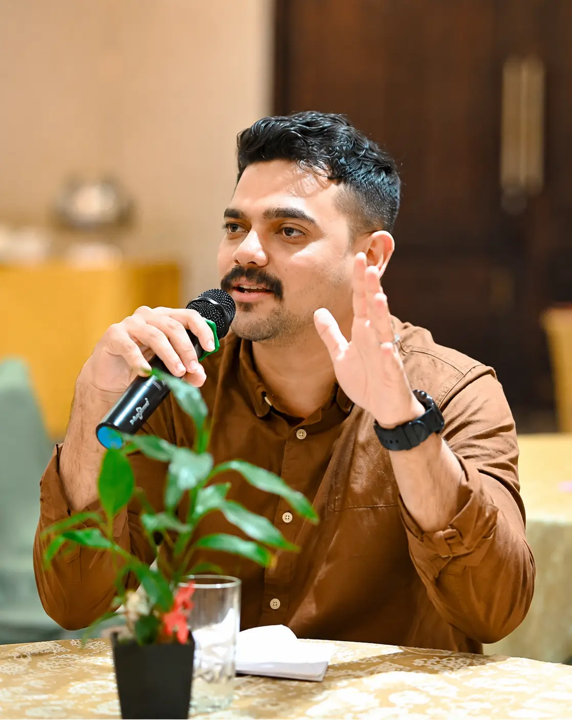A speaker holding a microphone at a Spunic event