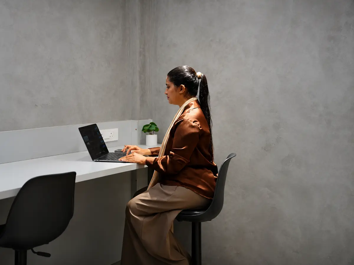 Person working on a laptop at a quiet desk at Spunic Kondotty