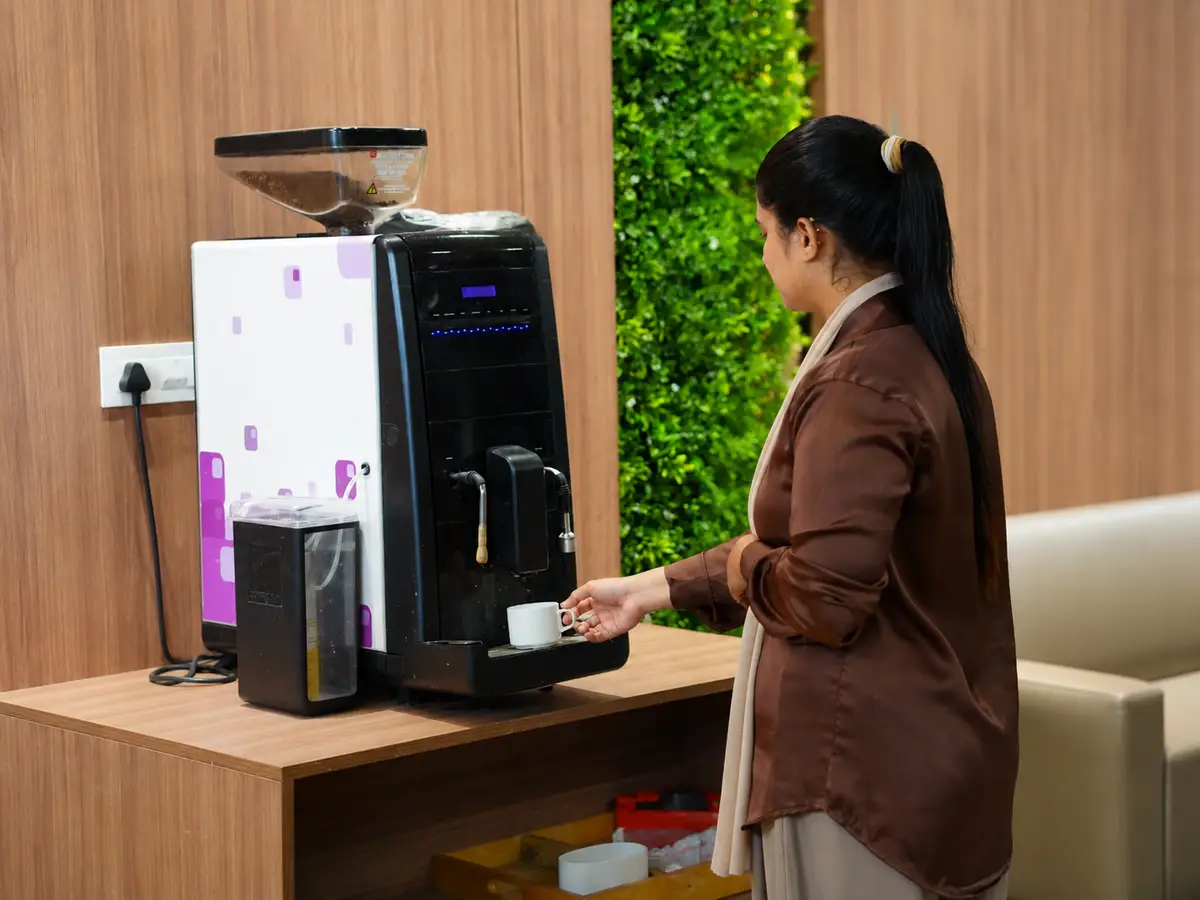 Member using the coffee machine in the pantry at Spunic Kondotty